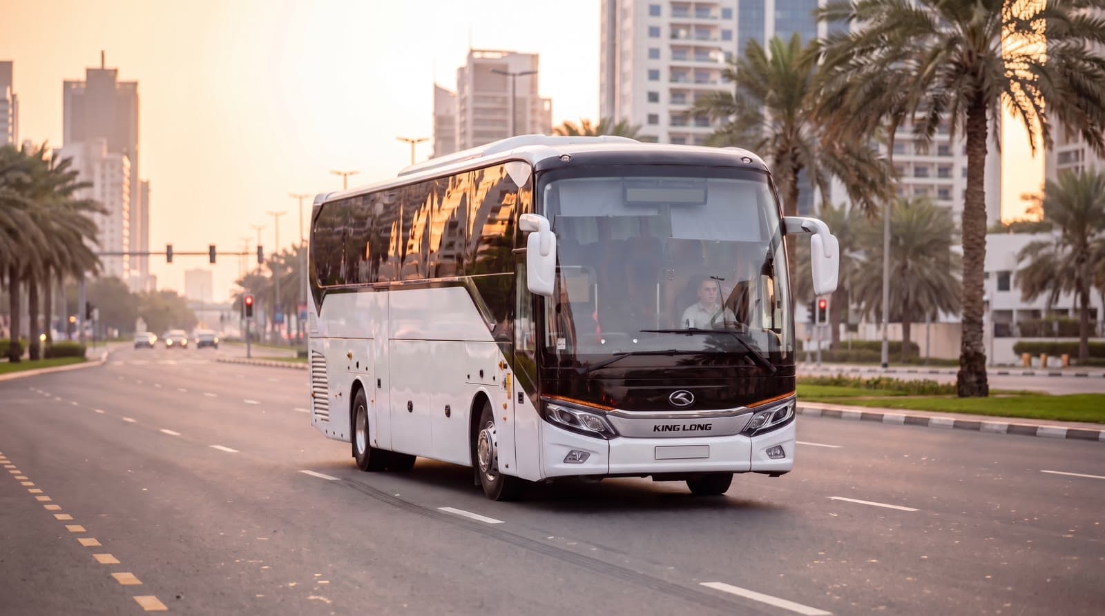 A white King Long coach of the type TFSL arranges through partner operators, on a Dubai road